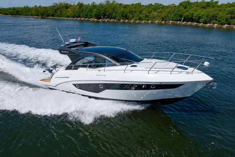 Slide: The Image of 2022 Schaefer 400 Sport yacht cruising on a scenic waterway. - 17