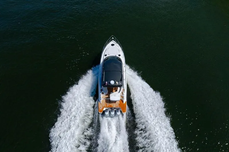 Slide: The Image of Aerial view of 2022 Schaefer 400 Sport boat cruising on water. - 9