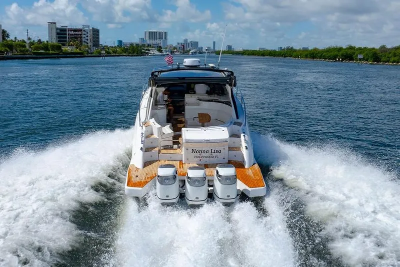 Slide: The Image of 2022 Schaefer 400 Sport yacht cruising on a sunny waterway. - 13
