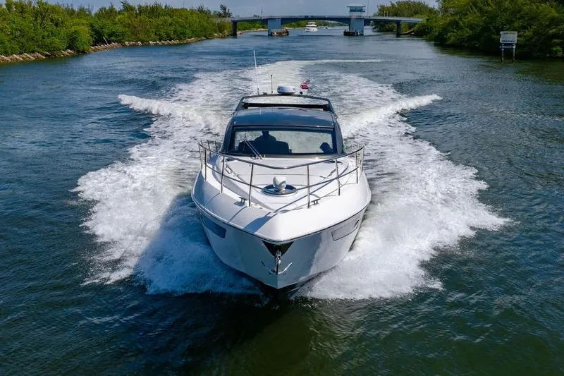 Slide: The Image of 2022 Schaefer 400 Sport yacht cruising on a scenic waterway. - 11