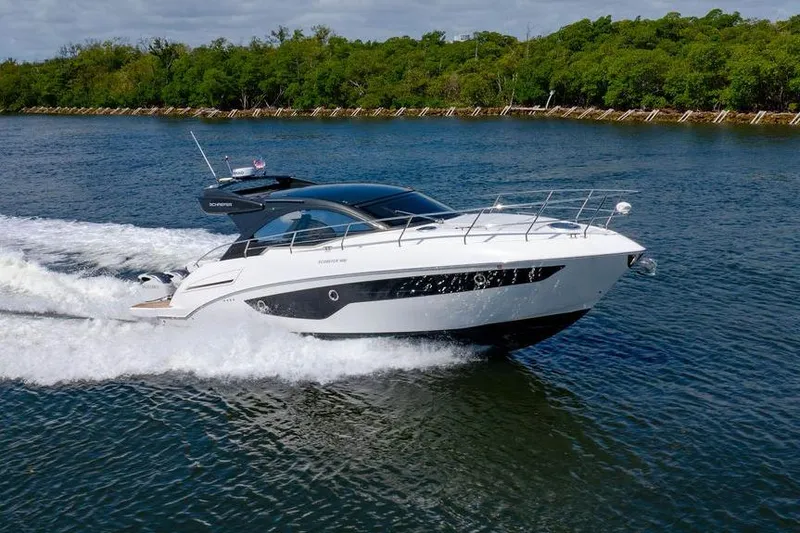 Slide: The Image of 2022 Schaefer 400 Sport yacht cruising on a scenic waterway. - 18