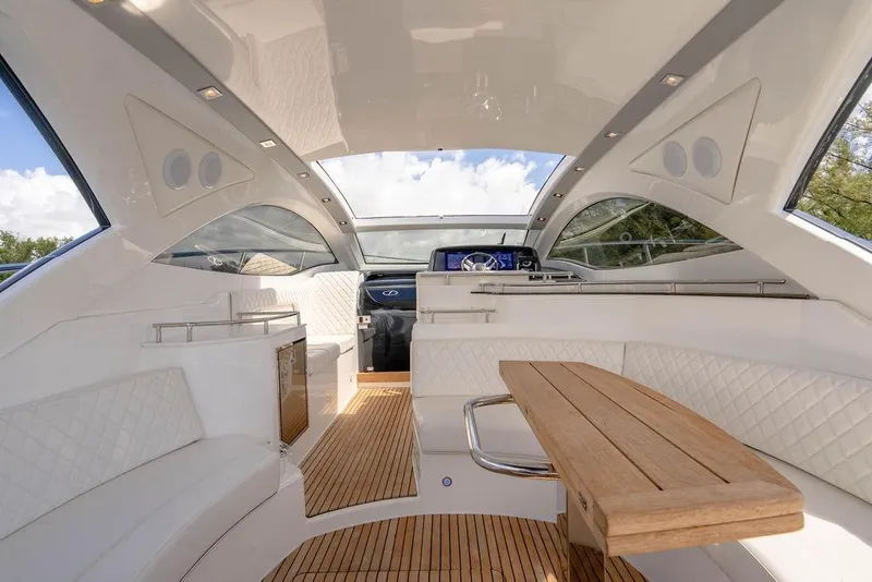 Slide: The Image of Luxurious interior of 2022 Schaefer 400 Sport yacht with elegant seating and wooden table. - 34
