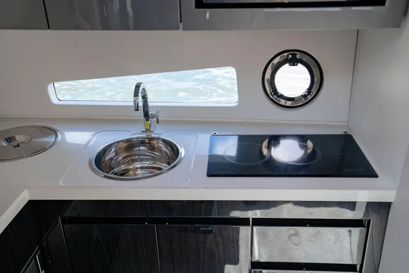 Slide: The Image of Modern kitchen area in 2022 Schaefer 400 Sport yacht with sink and stove. - 55