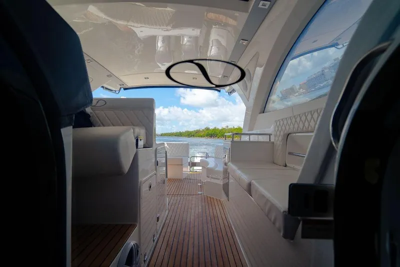 Slide: The Image of Interior view of 2022 Schaefer 400 Sport yacht with luxurious seating and wooden flooring. - 22