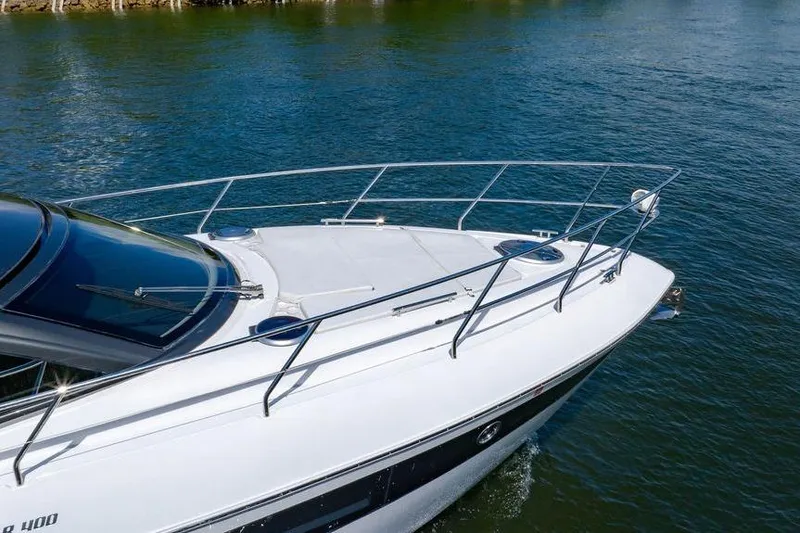 Slide: The Image of 2022 Schaefer 400 Sport yacht cruising on clear blue water. - 20