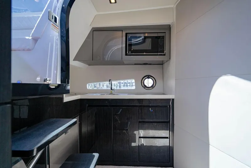 Slide: The Image of Modern kitchen interior of 2022 Schaefer 400 Sport yacht with microwave and sleek cabinetry. - 54
