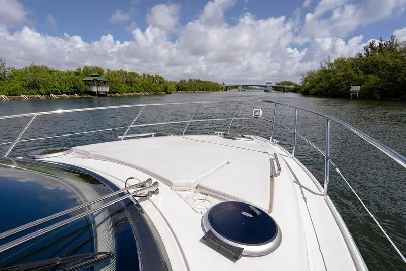 Slide: The Image of Bow view of 2022 Schaefer 400 Sport yacht cruising on a scenic river. - 47