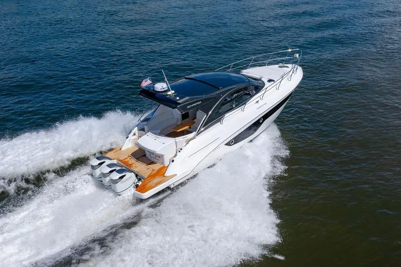 Slide: The Image of 2022 Schaefer 400 Sport yacht cruising on open water, showcasing sleek design and powerful engines. - 14
