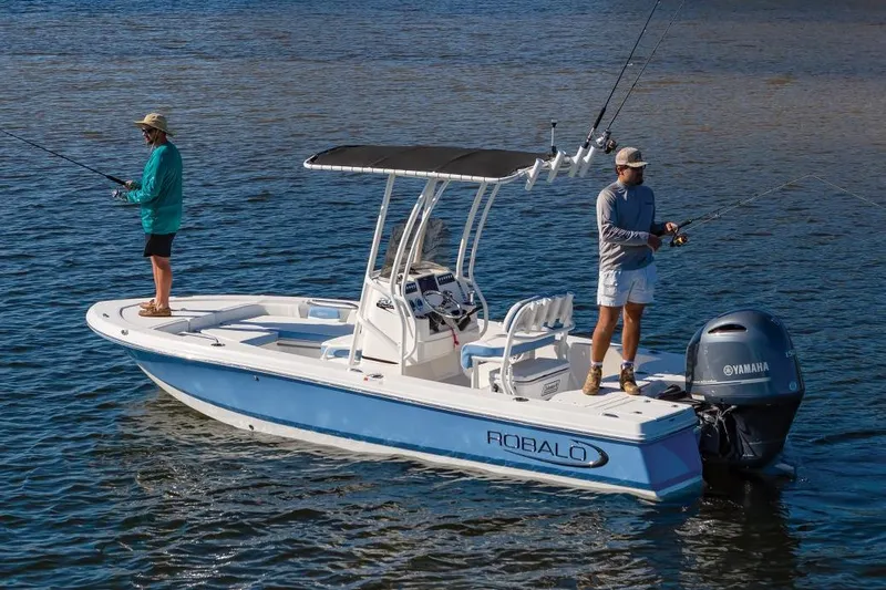 Slide: The Image of Manufacturer Provided Image: 2025 Robalo 206 Cayman boat with two people fishing on calm water. - 2