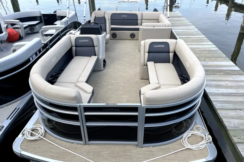 The Image of 2024 Harris Cruiser 230 pontoon boat docked, featuring spacious seating and modern design. - 0