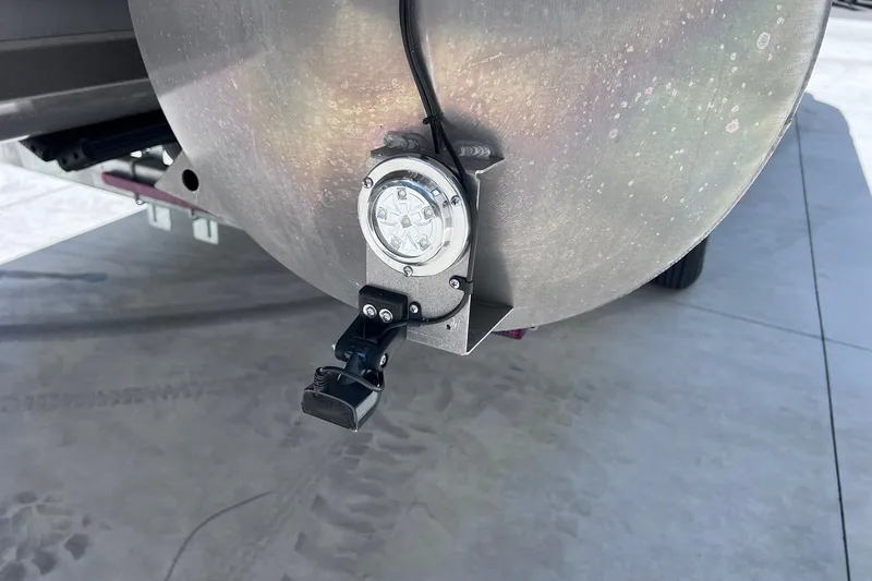 Slide: The Image of Close-up of 2024 Starcraft SLS 3 boat's rear light and camera on a metal surface. - 39