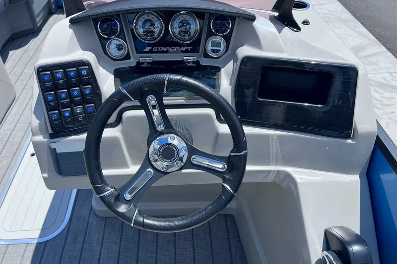 Slide: The Image of 2024 Starcraft SLS 3 boat dashboard with steering wheel and control panel. - 18
