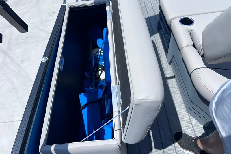 Slide: The Image of Open storage compartment on 2024 Starcraft SLS 3 boat, showing interior and seating area. - 35