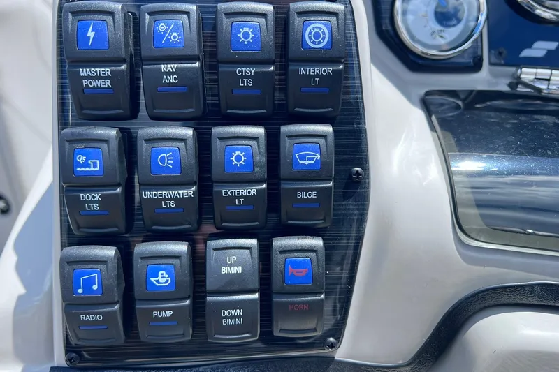 Slide: The Image of Control panel of a 2024 Starcraft SLS 3 boat with labeled switches. - 21
