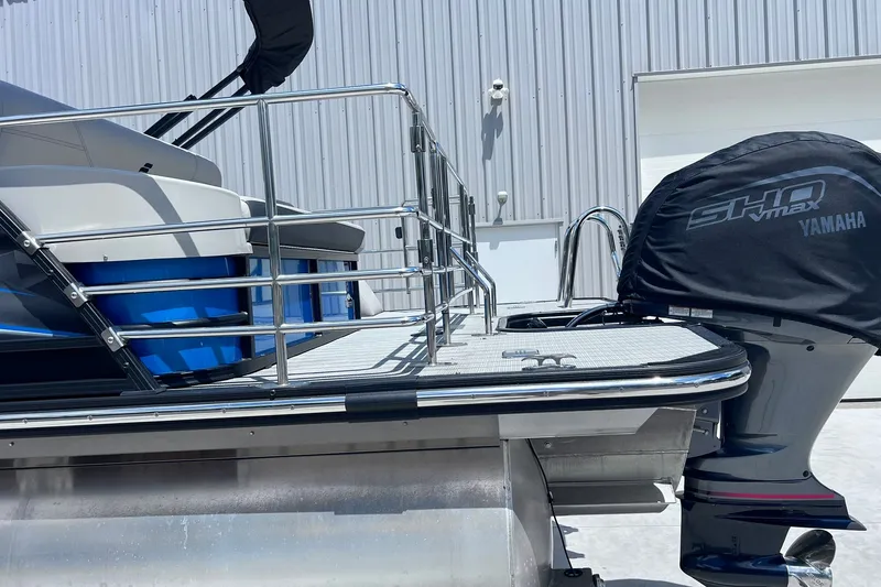 Slide: The Image of 2024 Starcraft SLS 3 boat with Yamaha SHO VMAX engine, docked near a metal building. - 37