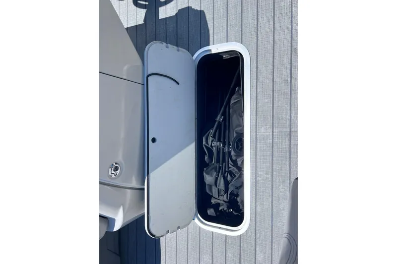 Slide: The Image of Open storage compartment on 2024 Starcraft SLS 3 boat deck. - 32