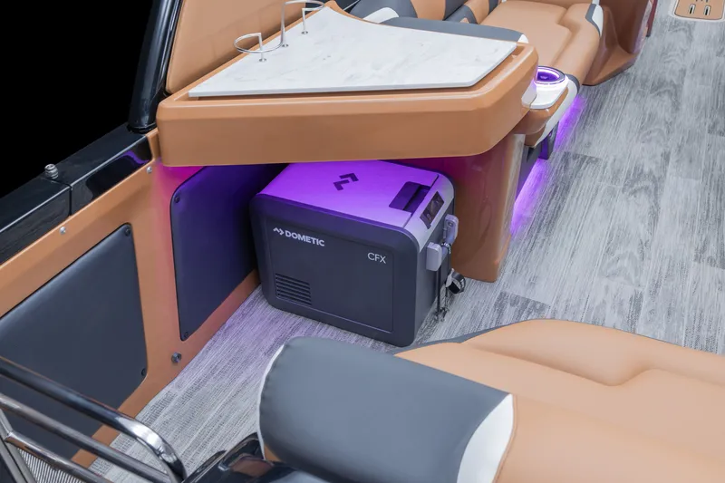 Slide: The Image of 2026 Tahoe Pontoon Grand Tahoe Elite Windshield 25 interior with Dometic CFX cooler and ambient lighting. - 17