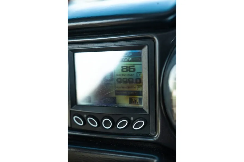 Slide: The Image of Dashboard display of a 2015 Moomba Mojo boat showing temperature and depth readings. - 25