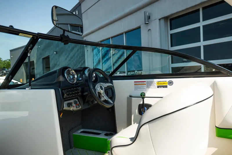 Slide: The Image of Interior of a 2015 Moomba Mojo boat, featuring steering wheel and dashboard controls. - 23
