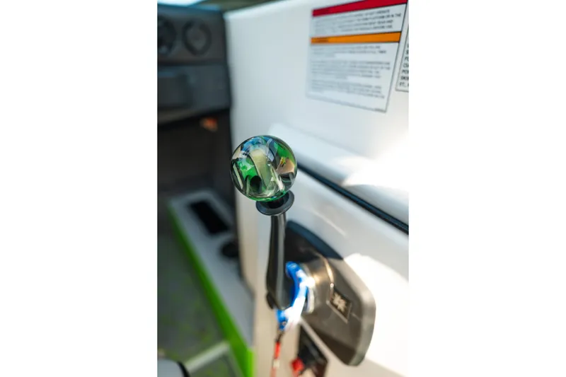 Slide: The Image of 2015 Moomba Mojo boat throttle lever with decorative knob in cockpit. - 28