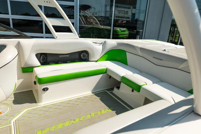 Slide: The Image of 2015 Moomba Mojo boat interior with green accents and premium seating. - 16