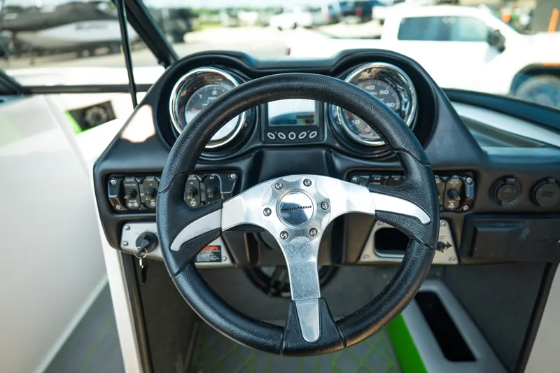 Slide: The Image of 2015 Moomba Mojo boat dashboard with steering wheel and gauges. - 27