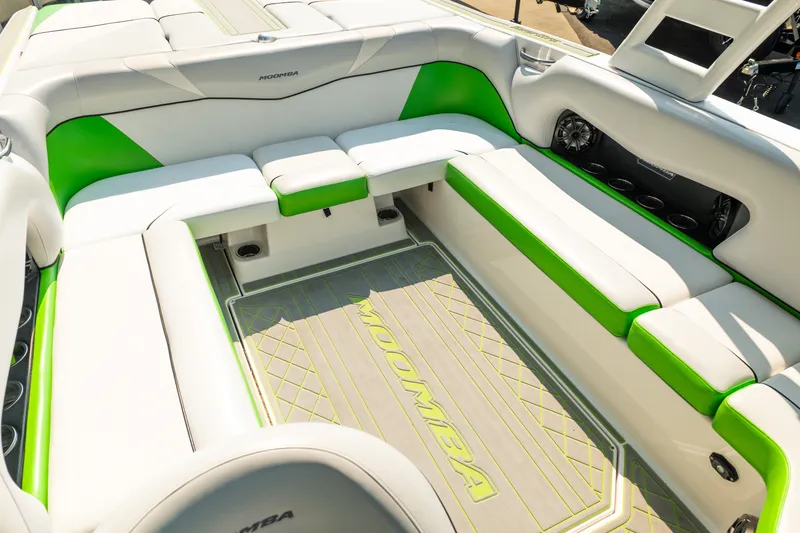 Slide: The Image of 2015 Moomba Mojo boat interior with white and green seating, spacious layout. - 31