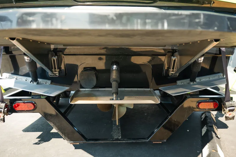 Slide: The Image of Rear view of a 2015 Moomba Mojo boat, showcasing its propeller and trim tabs. - 8