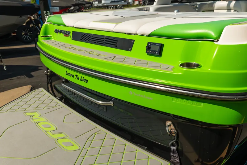Slide: The Image of 2015 Moomba Mojo boat with vibrant green detailing and "Learn To Live" slogan. - 9