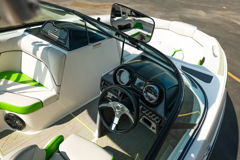 Slide: The Image of 2015 Moomba Mojo boat interior with green accents and modern dashboard design. - 19