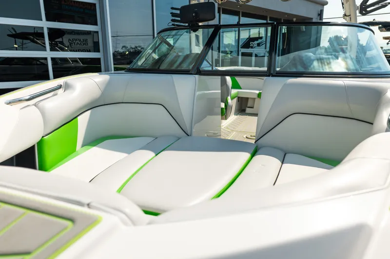 Slide: The Image of 2015 Moomba Mojo boat interior with white and green seating, showcasing modern design. - 13