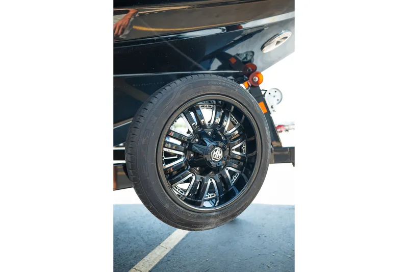 Slide: The Image of 2015 Moomba Mojo trailer wheel with black alloy rim design. - 11