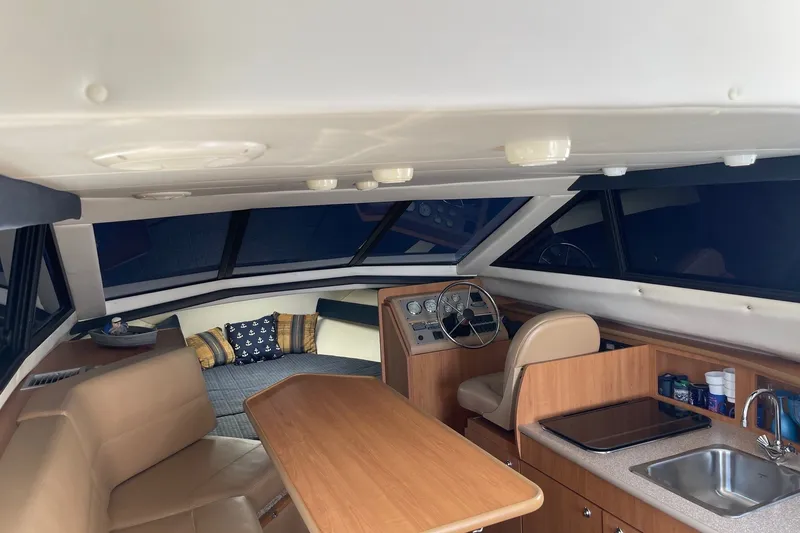 Slide: The Image of Interior of 2007 Bayliner Discovery 288 boat with seating, table, and helm. - 6