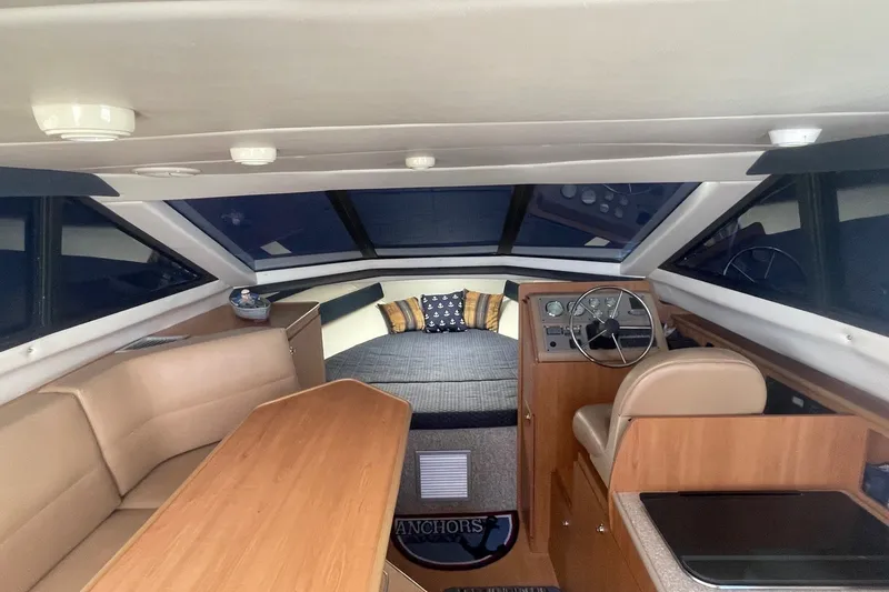 Slide: The Image of Interior of 2007 Bayliner Discovery 288 boat with helm, seating, and cabin area. - 11