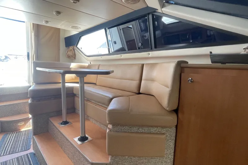 Slide: The Image of Interior of 2007 Bayliner Discovery 288 with beige seating and dining table. - 18