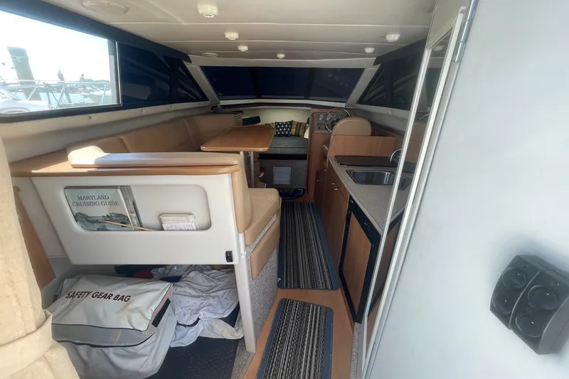 Slide: The Image of Interior of 2007 Bayliner Discovery 288 boat with seating, table, and kitchenette. - 20