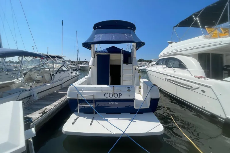Slide: The Image of 2007 Bayliner Discovery 288 docked at marina, sunny day, surrounded by other boats. - 30