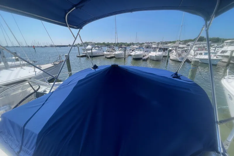 Slide: The Image of 2007 Bayliner Discovery 288 docked in a marina, surrounded by other boats. - 27