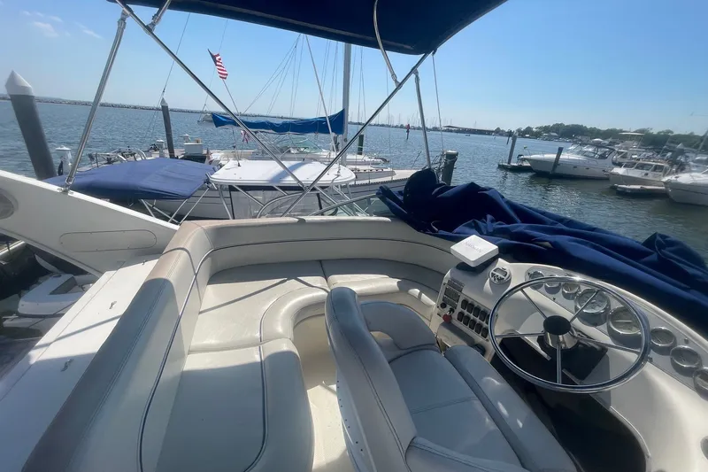 Slide: The Image of 2007 Bayliner Discovery 288 boat interior with steering wheel, docked at marina. - 34