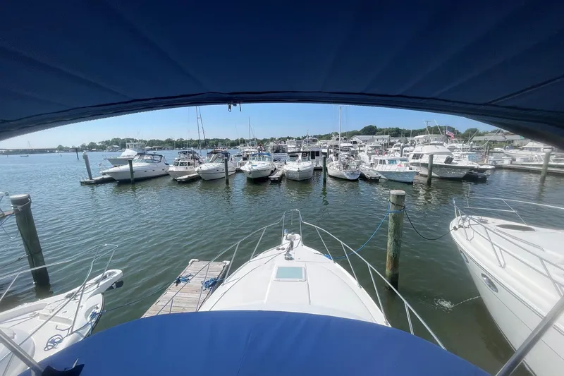Slide: The Image of 2007 Bayliner Discovery 288 docked in a marina with multiple boats. - 28