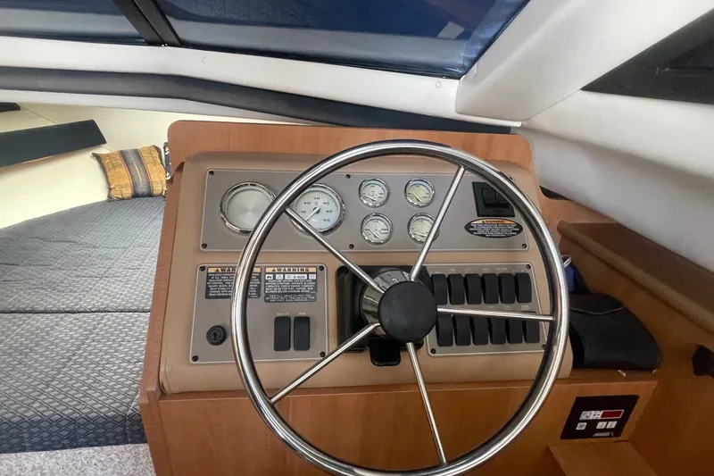 Slide: The Image of 2007 Bayliner Discovery 288 helm with steering wheel and instrument panel. - 15