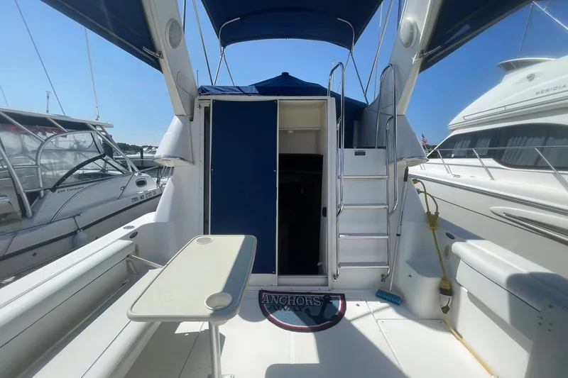 Slide: The Image of 2007 Bayliner Discovery 288 boat interior with seating, table, and ladder. - 23