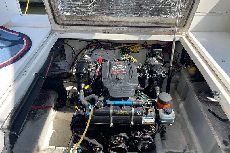Slide: The Image of Engine compartment of a 2007 Bayliner Discovery 288 boat, showcasing the motor and wiring. - 25