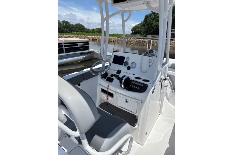 Slide: The Image of 2024 NauticStar 222L Offshore boat console with steering wheel and controls. - 1