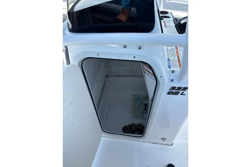 Slide: The Image of 2024 NauticStar 222L Offshore boat storage compartment with open door. - 9
