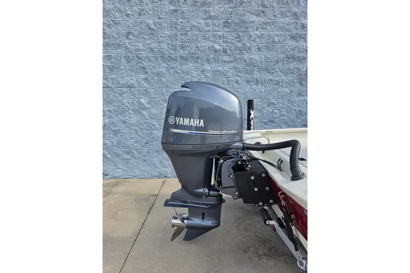 Slide: The Image of 2014 Xpress H22 Bay boat with Yamaha outboard motor against a gray brick wall. - 3