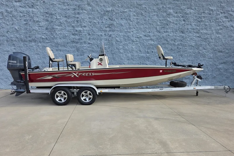 The Image of 2014 Xpress H22 Bay boat on trailer with Yamaha outboard motor. - 1