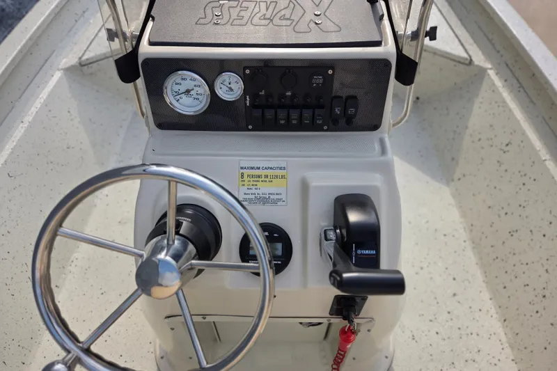 Slide: The Image of Steering console of a 2014 Xpress H22 Bay boat with Yamaha controls. - 6