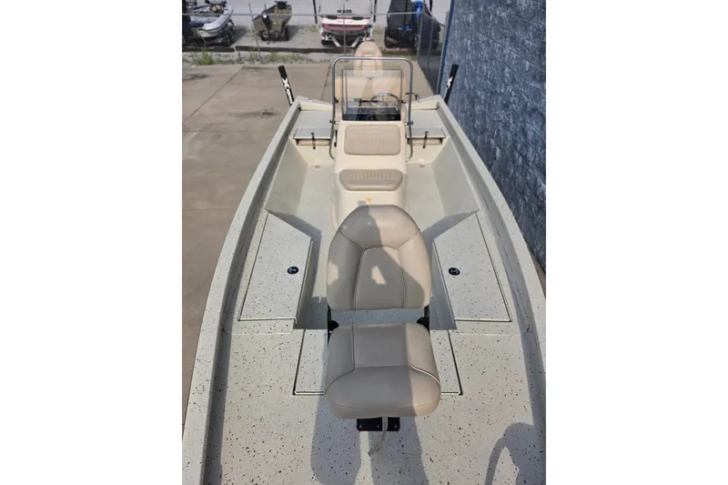 Slide: The Image of 2014 Xpress H22 Bay boat interior with beige seating and console. - 9