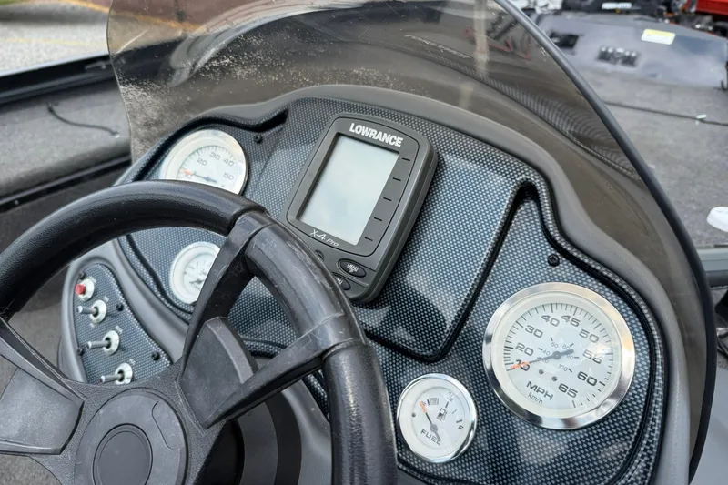 Slide: The Image of Dashboard of a 2014 Lowe Stinger 175 boat with gauges and Lowrance display. - 11